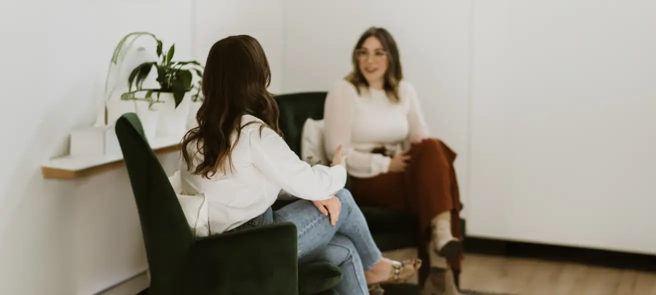 Hero image of two people sitting and talking